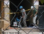 The next three pics are of the construction worker, as he was donning his boots. Why did the two workers take them off to perform their task?