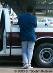 A dude with boots off, standing under a tree, waiting for traffic to clear, oblivious to the fact he was driving me crazy with those socked dawgs.